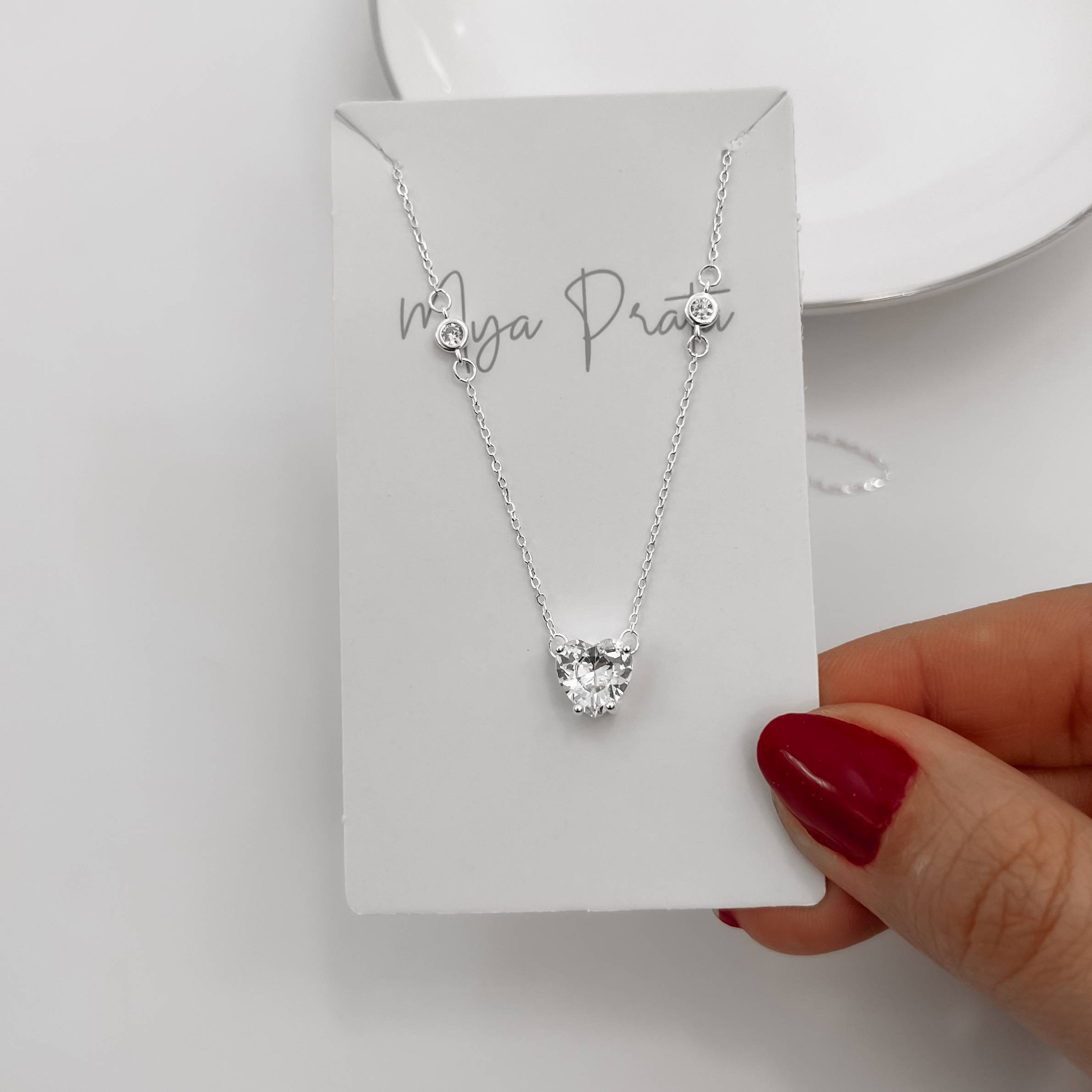 Imagem Secundária Colar entremeios zircônias redonda e coração 8mm 40+5cm