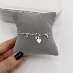 Pulseira entremeio bolas e círculo com pingentes olho grego, trevo e zircônias